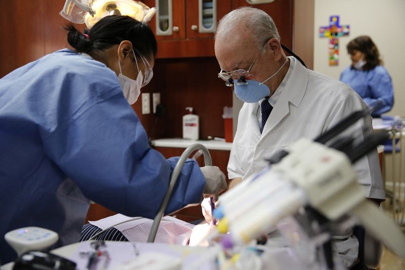 &copy; Reuters. FILE PHOTO: Some of the estimated 2,200 clients each year make use of the dental services at the Spanish Catholic Center agency of the Diocese of Washington Catholic Charities in Washington, September 16, 2015.REUTERS/Jonathan Ernst/File Photo