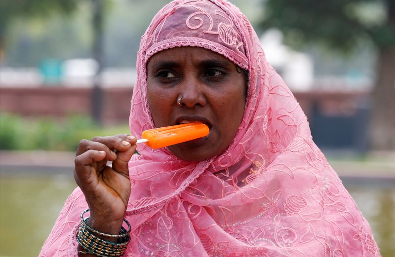&copy; Reuters. Mulher toma sorvete em dia quente em Nova Délhi, Índia. REUTERS/Priyanshu Singh