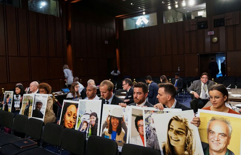 &copy; Reuters. FILE PHOTO: Family members hold photographs of Boeing 737 MAX crash victims lost in two deadly 737 MAX crashes that killed 346 people as they wait for Boeing CEO Dennis Muilenburg to testify before a Senate Commerce, Science and Transportation Committee h