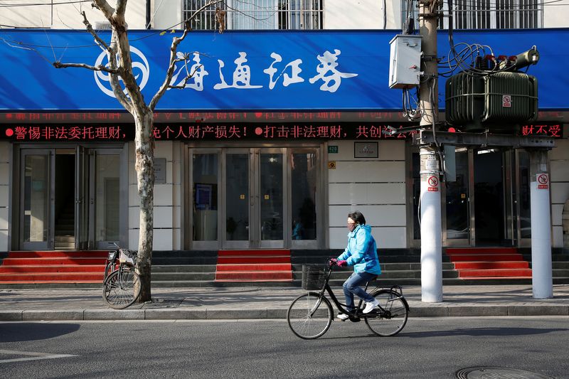 &copy; Reuters. A cyclist rides past a branch of Haitong Securities, in Shanghai, China, January 26, 2017. REUTERS/Aly Song