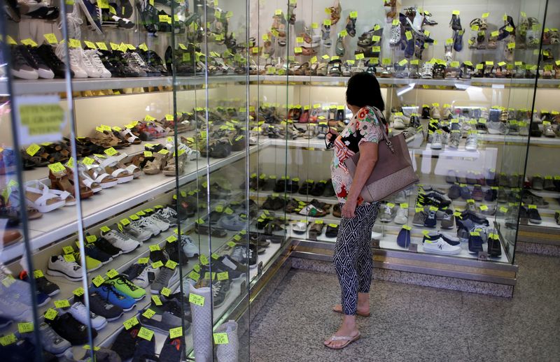 &copy; Reuters. FILE PHOTO: A woman stands in a shoes shop in Rome, Italy, August 11, 2016. Picture taken August 11, 2016. REUTERS/Max Rossi/File Photo
