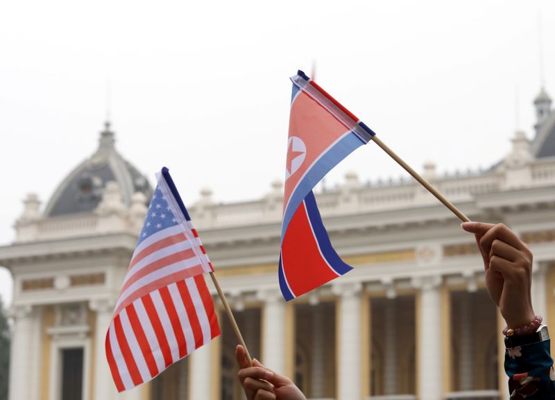&copy; Reuters. Residents hold US and North Korean flags while they wait for motorcade of North Korea's leader Kim Jong Un en route to the Metropole Hotel for the second US- North Korea summit in Hanoi, Vietnam February 28, 2019. REUTERS/Kham/File Photo
