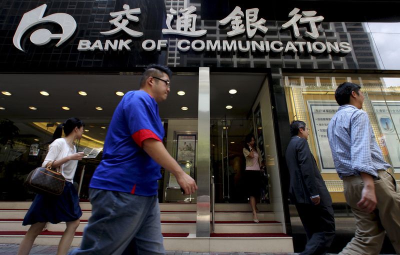 &copy; Reuters. People walk past the Bank of Communications at its central branch in the financial district of Hong Kong August 19, 2009. REUTERS/Aaron Tam/File Photo
