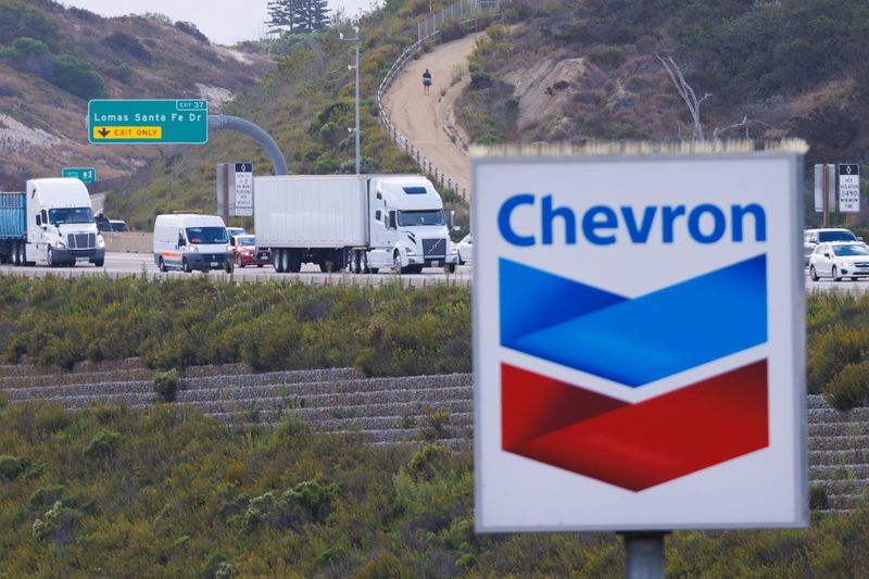 &copy; Reuters. FILE PHOTO: A Chevron gas station sign is shown after Chevron Corp said it would buy Hess Corp in a $53 billion all-stock deal, in Encinitas, California, U.S., October 23, 2023. REUTERS/Mike Blake/File Photo