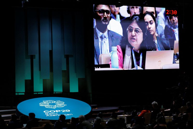 © Reuters. A screen displays Chandni Raina of India as she speaks during a closing plenary meeting at the COP29 United Nations Climate Change Conference, in Baku, Azerbaijan November 24, 2024. REUTERS/Maxim Shemetov