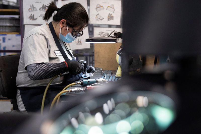 © Reuters. FILE PHOTO: A factory worker works on a machined aircraft part at Abipa Canada in Boisbriand, Quebec, Canada May 10, 2023. REUTERS/Evan Buhler/File Photo