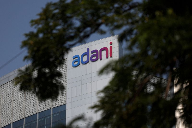 © Reuters. FILE PHOTO: The logo of the Adani Group is seen on the facade of its Corporate House on the outskirts of Ahmedabad, India, November 21, 2024. REUTERS/Amit Dave/File Photo