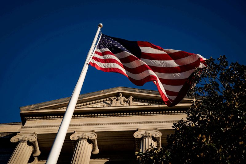 © Reuters. FILE PHOTO: An American flag waves outside the U.S. Department of Justice Building in Washington, U.S., December 15, 2020. REUTERS/Al Drago//File Photo