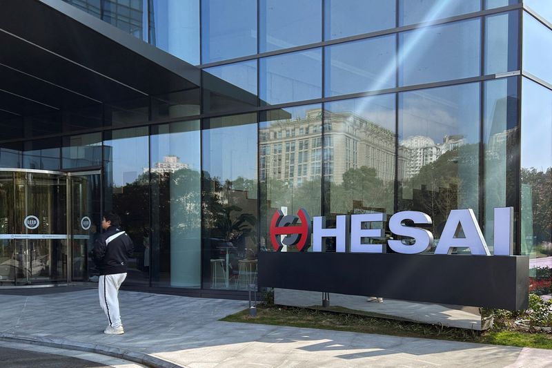 © Reuters. A person walks outside the headquarters of lidar sensor maker Hesai Group in Shanghai, China November 26, 2024. REUTERS/Zoey Zhang/Files