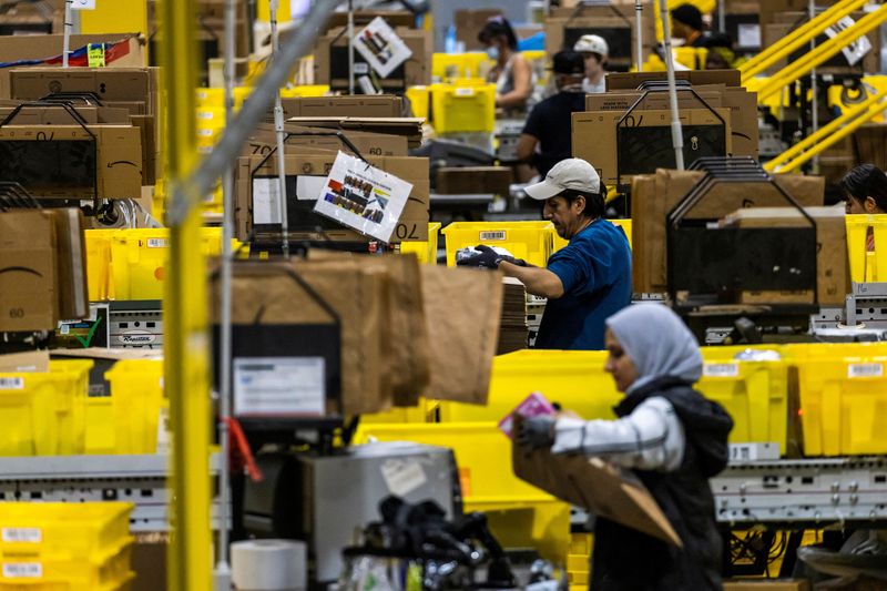 © Reuters. Workers select products during Cyber Monday at the Amazon's fulfillment center in Robbinsville, New Jersey, U.S., December 2, 2024. REUTERS/