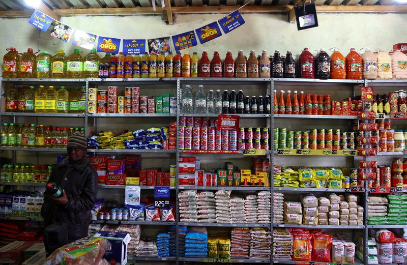 &copy; Reuters. FILE PHOTO: A man looks at an item before buying at a spaza shop in Thembisa, on the East Rand, in South Africa, August 2, 2023. REUTERS/Siphiwe Sibeko/File Photo