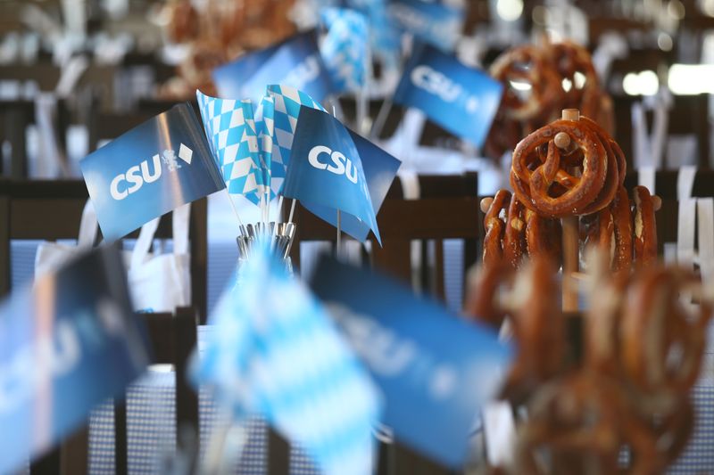 &copy; Reuters. Flags with the logo of the Christian Social Union (CSU) and brezels are seen ahead of a CSU election campaign rally in Munich, Germany October 12, 2018. REUTERS/Michael Dalder/Files