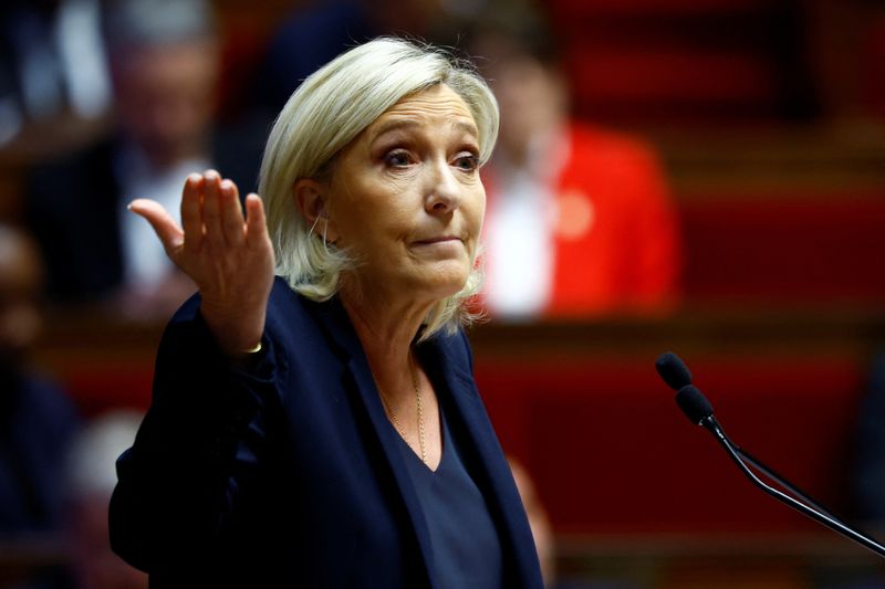 © Reuters. French far-right leader and member of parliament Marine Le Pen, President of the French far-right National Rally (Rassemblement National - RN) party parliamentary group, gestures as she delivers a speech during a debate on two motions of no-confidence against the French government, tabled by the alliance of left-wing parties the 