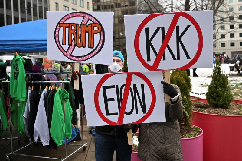 © Reuters. Protesters hold signs during the 