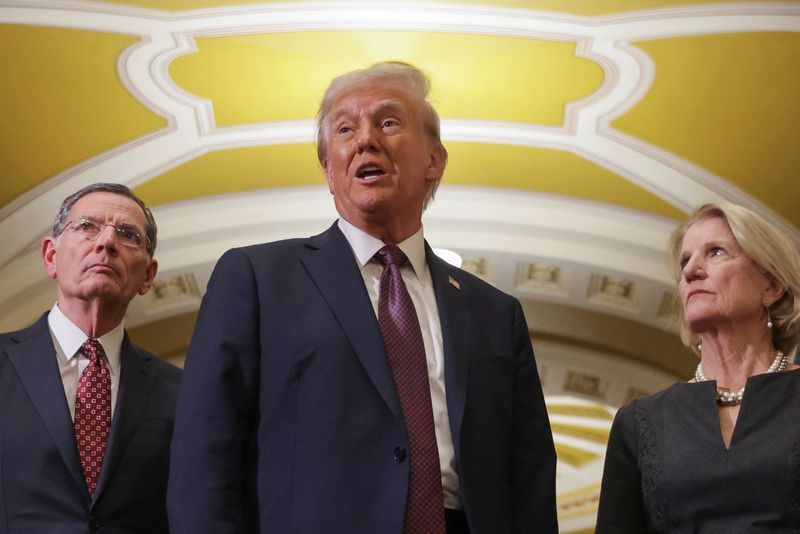 © Reuters. FILE PHOTO: US President-elect Donald Trump speaks as US Senator Shelley Moore Capito (R-WV) and US Senator John Barrasso (R-WY) look on after a meeting with congressional Republicans at the US Capitol in Washington, US January 8, 2025. REUTERS/Jenna Moon/Archive photo