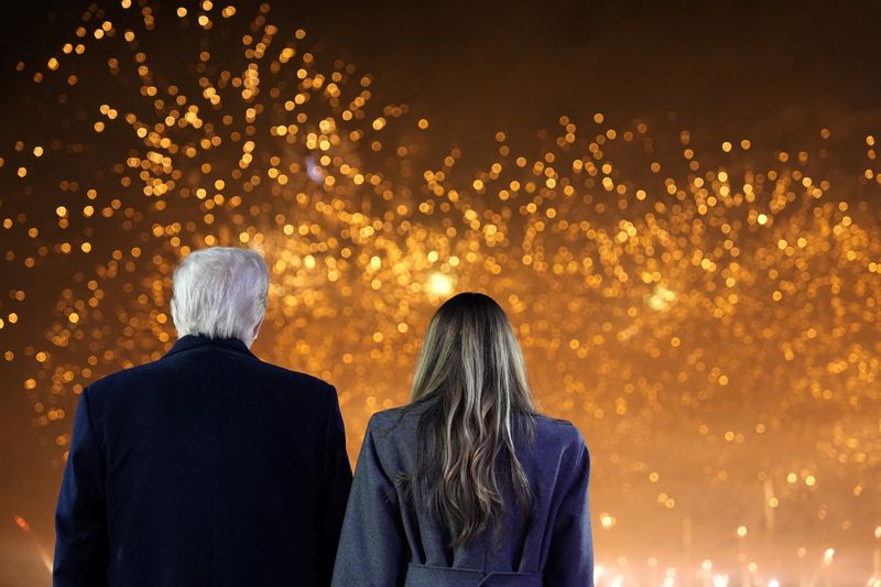 © Reuters. FILE PHOTO: US President-elect Donald Trump and Melania Trump watch fireworks at Trump National Golf Club, in Sterling, Virginia, US on January 18, 2025. Alex Brandon/Pool via Reuters/File Photo