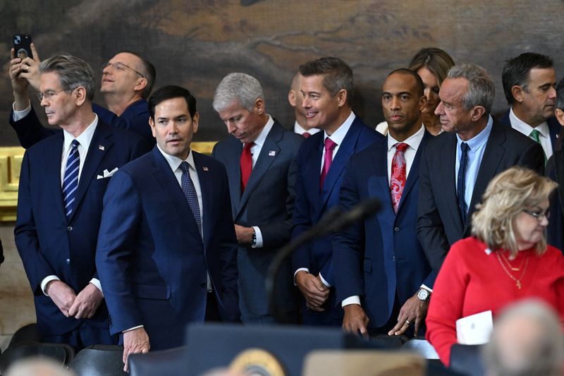 © Reuters. (L-R) US Secretary of Treasury nominee Scott Bessent, Secretary for Veterans Affairs nominee Doug Collins, Secretary of State nominee Marco Rubio, Secretary of Energy nominee Chris Wright, Secretary of Transportation nominee Sean Duffy,  Secretary of Housing and Urban Development nominee Scott Turner and Secretary of Health and Human Services nominee Robert F. Kennedy Jr. attend the inauguration ceremony before Donald Trump is sworn in as the 47th US President in the US Capitol Rotunda in Washington, DC, on January 20, 2025.     SAUL LOEB/Pool via REUTERS