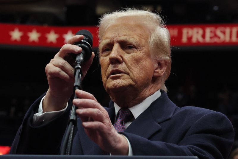 &copy; Reuters. FILE PHOTO: U.S. President Donald Trump adjusts the microphone during the inaugural parade inside Capital One Arena on the inauguration day of his second presidential term, in Washington, U.S. January 20, 2025. REUTERS/Carlos Barria/File Photo