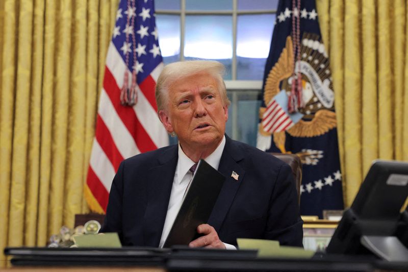  U.S. President Donald Trump signs documents arsenic  helium  issues enforcement  orders and pardons for January 6 defendants successful  the Oval Office astatine  the White House connected  Inauguration Day successful  Washington, U.S., January 20, 2025.  REUTERS/Carlos Barria/File Photo