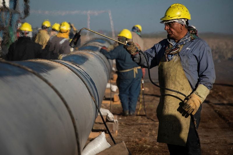 &copy; Reuters. FILE PHOTO: People work during the construction of the Nestor Kirchner gas pipeline in Macachin, La Pampa, Argentina April 26, 2023. REUTERS/Martin Cossarini/File Photo