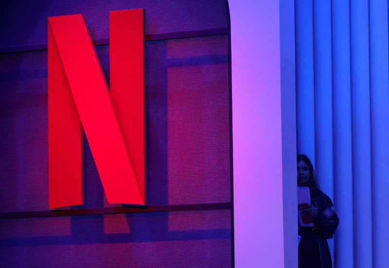  A woman stands next to a logo of Netflix during an event in Mumbai, India, February 29, 2024. REUTERS/Francis Mascarenhas/File Photo