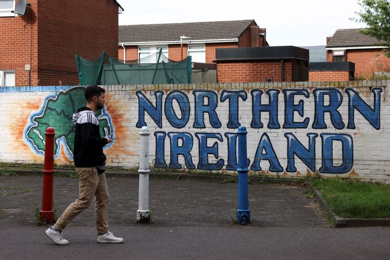 &copy; Reuters. FILE PHOTO: A man walks past a mural that says ‘Northern Ireland’, on Sandy Row in Belfast, Northern Ireland, August 11, 2024. REUTERS/Hollie Adams/File Photo