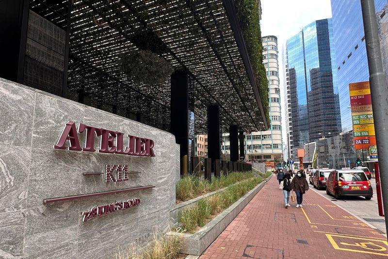 &copy; Reuters. FILE PHOTO: People walk past developer New World Development's office tower, K11 Atelier King's Road, in North Point of Hong Kong, China February 2, 2023. REUTERS/Clare Jim/File Photo