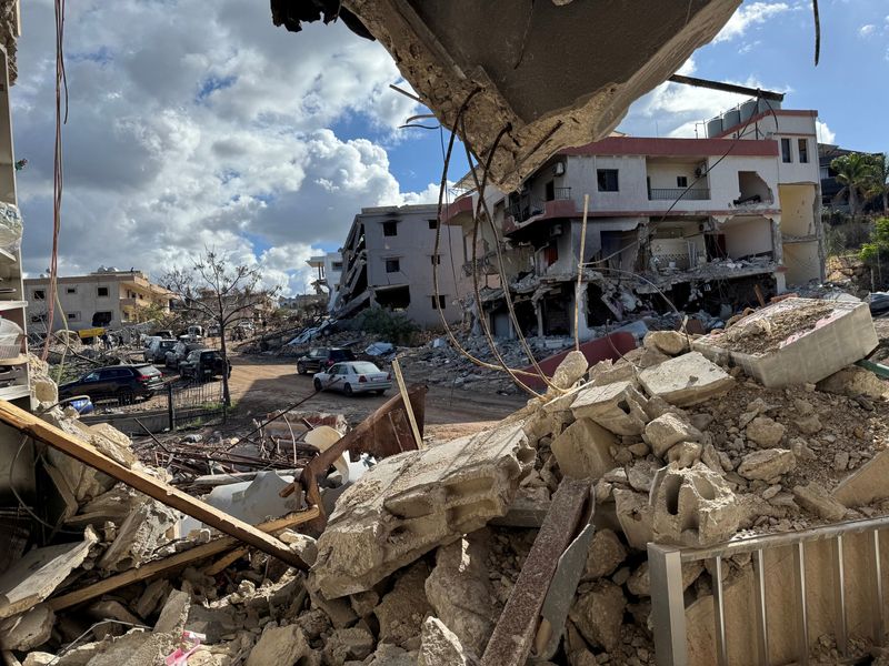 &copy; Reuters. Cars drive past damaged buildings, as residents return to Naqoura, near the border with Israel, southern Lebanon, January 23, 2025. REUTERS/Ali Hankir 