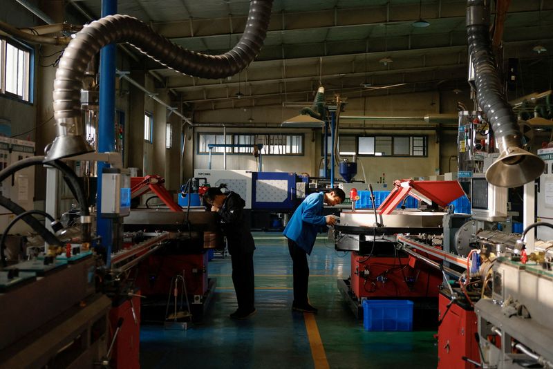  Workers monitor the production line of drip tape fittings at a factory of DAYU Water Group Co, in Jiuquan, during an organised media tour in Gansu province, China October 18, 2024. REUTERS/Tingshu Wang/File Photo