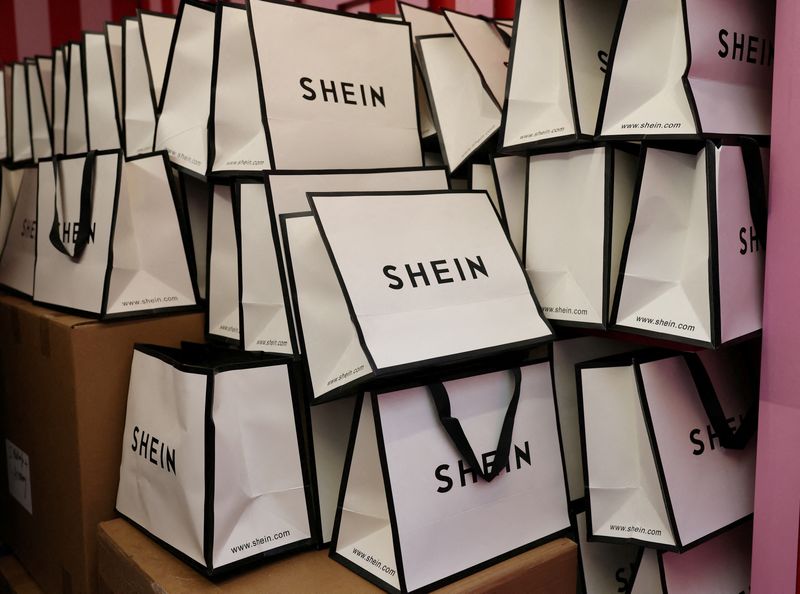 &copy; Reuters. FILE PHOTO: A company logo for fashion brand Shein is seen on a pile of gift bags on its Christmas bus as part of a nationwide promotional tour in Liverpool, Britain, December 14, 2024. REUTERS/Phil Noble/File Photo