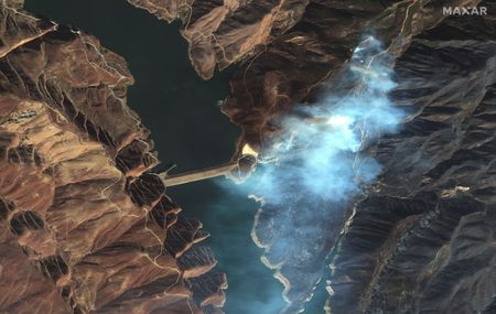 With rain in forecast, weary Los Angeles hopeful of progress against wildfires