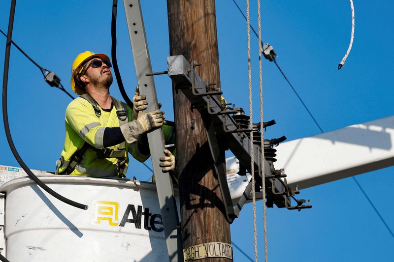  An L.A. Department of Water and Power electrical worker installs hardware to support power lines following the Palisades Fire, in Pacific Palisades, California, U.S., January 17, 2025. REUTERS/Fred Greaves/File Photo