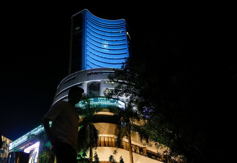 &copy; Reuters. FILE PHOTO: A man walks past the lit up Bombay Stock Exchange (BSE) building during Diwali, the Hindu festival of lights, in Mumbai, India, November 1, 2024. REUTERS/Francis Mascarenhas/File Photo