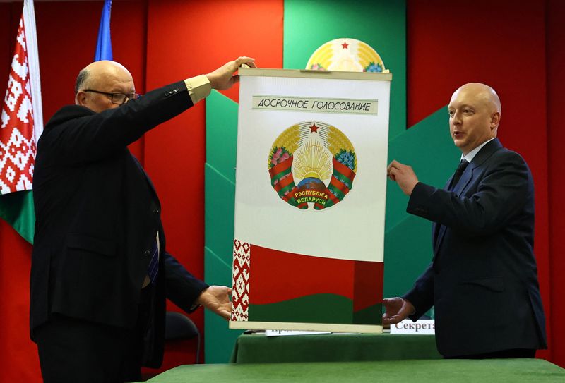 © Reuters. Members of an electoral commission empty a ballot box to count votes during the presidential election in Minsk, Belarus January 26, 2025. A sign on the ballot box reads: 