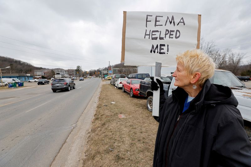 &copy; Reuters. FILE PHOTO: Swannanoa resident Lucy Bickers, who received assistance from FEMA after Hurricane Helene damaged her property, holds a sign in support of the government agency as she waits on the route of visiting U.S. President Donald Trump's motorcade in S