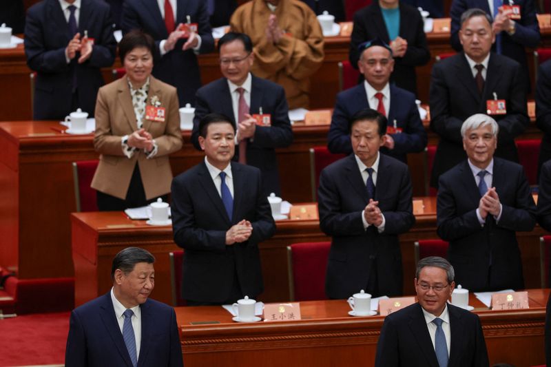 China will work to firmly advance 'reunification' with Taiwan, premier says