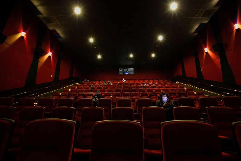 Theaters bet big on massive screens, booming sound and recliners to lure movie fans