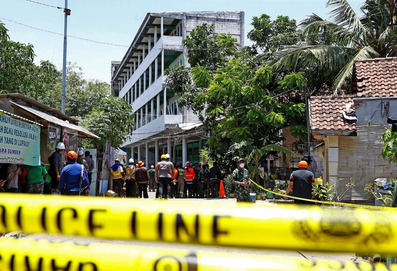 Ambulances line up near collapsed Indonesian school building as search for trapped students continues